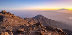 Mount Meru with Kilimanjaro in the distance near Arusha in Tanzania. Africa. Mt Meru is located 60 kilometres west of Mount Kilimanjaro. Sunrise.